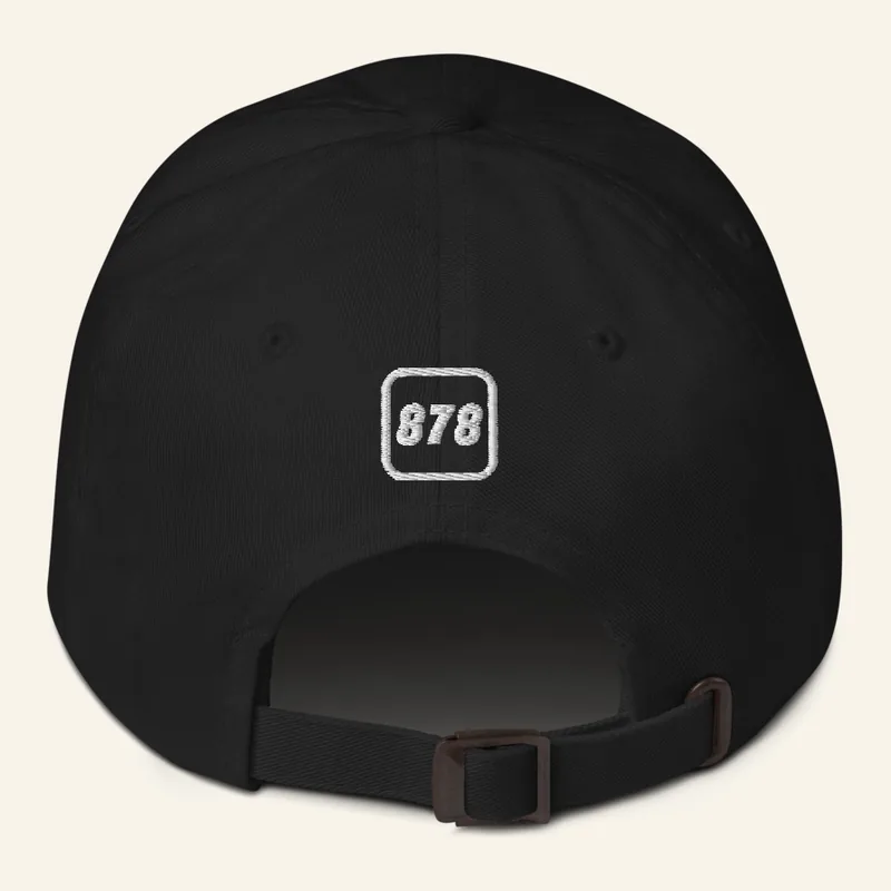 Black dad hat, back, with a small 878 icon above the strap